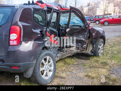 Wrecked crumpled car from the right side after a severe accident with a distorted body and broken windows, after a powerful side impact Stock Photo