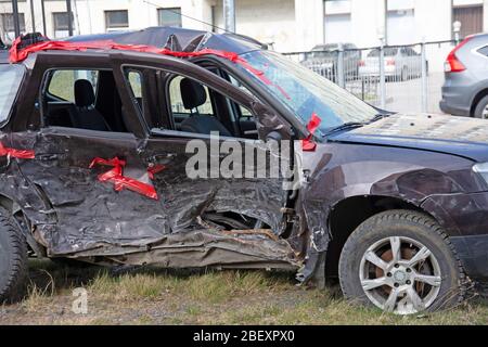 Wrecked crumpled car from the right side after a severe accident with a distorted body and broken windows, after a powerful impact side view Stock Photo