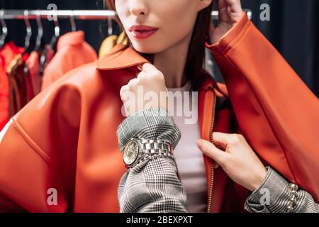 cropped view of stylist touching jacket on model cropped view of stylist touching jacket on model