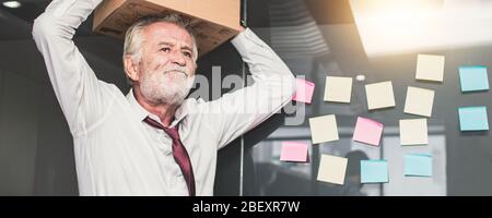 retirement and  lay off concept, old businessman preparing box and keeping objects out office. Frustration and loss work Stock Photo