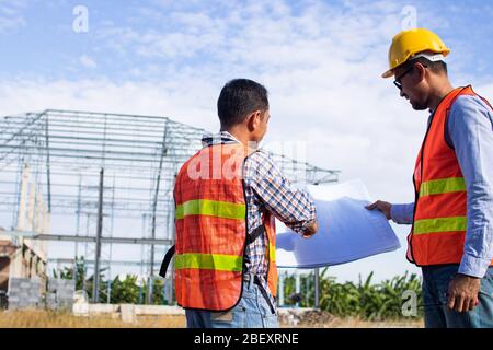Engineer or inspector checking progressing work in construction site Stock Photo