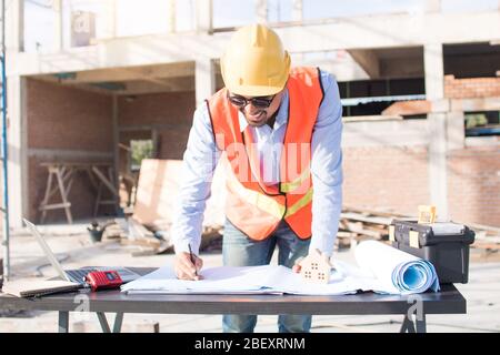 Engineer or inspector checking progressing work in construction site Stock Photo