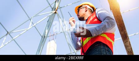 Engineer or inspector checking progressing work in construction site Stock Photo