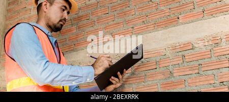 Engineer or inspector checking progressing work in construction site Stock Photo