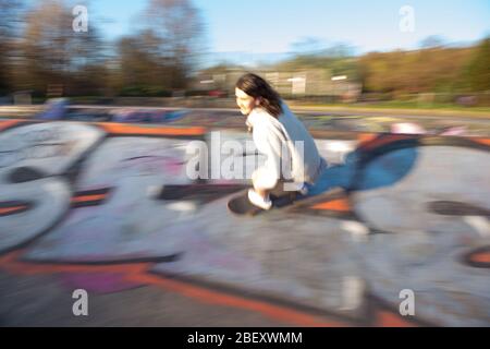 Glasgow UK. 15 April 2019.  Pictured: A female skater takes advantage of the free concrete on an empty Kelvingrove skatepark in Glasgow during the Coronavirus Lockdown.  Normally this skate park would be busy with hundreds of people making it difficult to use all of the park at once. Credit: Colin Fisher/Alamy Live News. Stock Photo