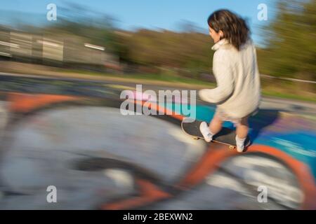 Glasgow UK. 15 April 2019.  Pictured: A female skater takes advantage of the free concrete on an empty Kelvingrove skatepark in Glasgow during the Coronavirus Lockdown.  Normally this skate park would be busy with hundreds of people making it difficult to use all of the park at once. Credit: Colin Fisher/Alamy Live News. Stock Photo
