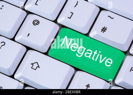 A keyboard with the word Negative in white lettering on a green enter key. Test for Coronavirus Covid-19 testing concept. England, UK, Britain Stock Photo