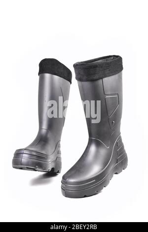 black high insulated boots for hunting off-road fishing and traveling in the cold season on a white background isolate close-up Stock Photo