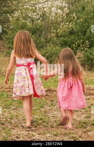 Two girls holding hands while walking around Paris Stock Photo - Alamy