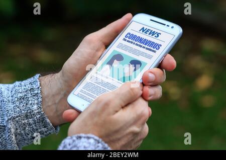 Coronavirus News. Man with smartphone in his hands reading about covid-19 virus. Online news in the screen of phone. Stock Photo
