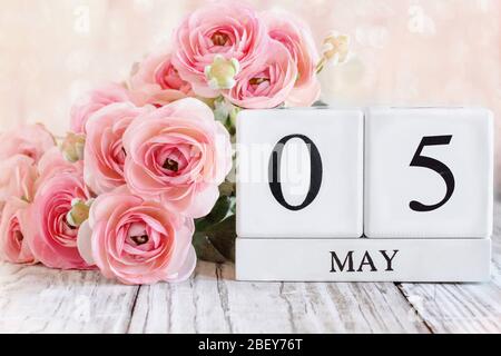 Generic white wood calendar blocks with the date May 5th for Cinco de Mayo. Selective focus with blurred background. Stock Photo