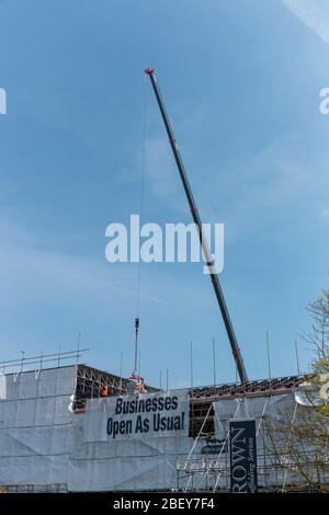 Bristol-April 2020-England-a close up view of a large crane on site moving large amounts of tiles and steel pipes Stock Photo