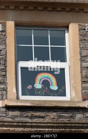 Bristol-April 2020-England-a close up view of a painted rainbow that has been stuck onto the inside of a window overlooking a main street-hope for the Stock Photo