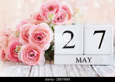 Generic white wood calendar blocks with the date May 27th. Selective focus with blurred background. Stock Photo