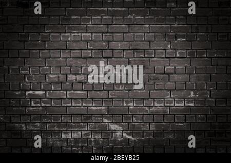 Texture or background of a dark brick wall with scratches and scuffs at night Stock Photo