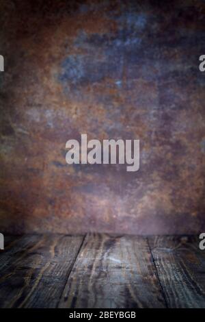 Abstract of empty old wood table with a blurred rusted metal sheet backdrop with free space for text for background. For product display or design vis Stock Photo