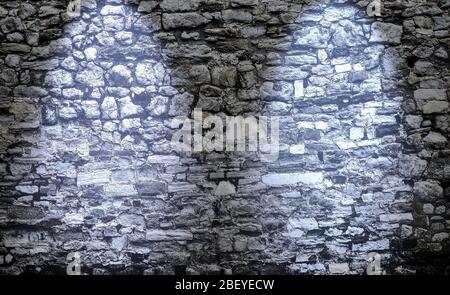 Two beautiful blue spotlights shining at an aged brick wall Stock Photo