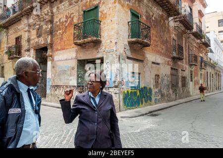 Two CVP people ( 'Cuerpo de Vigilancia y Protección'), or security guards, talking on Calle San Ignacio, Havana old town, Cuba Stock Photo