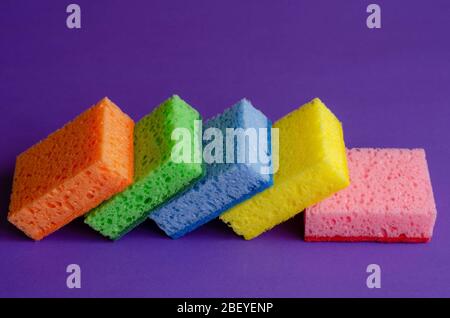 Kitchen multi-colored sponges. Five porous kitchen sponges in various colors. Commercial cleaning company. Close-up. Selective focus. Stock Photo