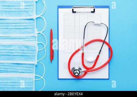 Prevention Coronovirus, Covid-19 test analysis form and Face surgical mask. Doctor appointment. Stethoscope, medical documents on doctors workplace Stock Photo