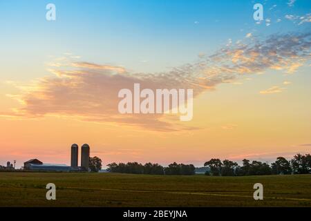 Farm buildings with silos at dawn, Wonderland Road, near London, Ontario, Canada Stock Photo