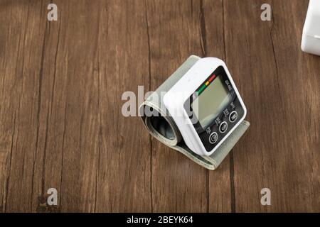 Tech device showing medical instructions on a wooden table, top view Stock Photo