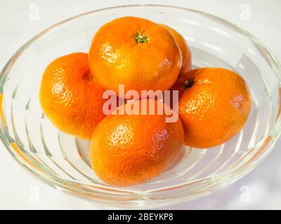 Easy peeler mandarin oranges in a glass bowl on a white background Stock Photo