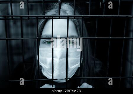 Young unhappy girl imprison at home for protection corona virus. coronavirus and epidemic virus symptoms. Stock Photo