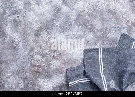 Linen napkin or towel on grey kitchen table Stock Photo