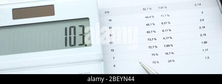 On report with numbers lies calculator and pen Stock Photo