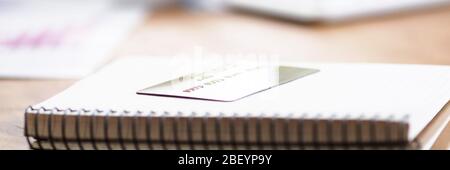 Table in bank notepad with spring and credit card Stock Photo