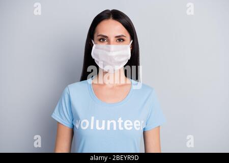 Close-up portrait of her she nice attractive lovely content girl medic doc voluntary work worker job wearing protective mask isolated over grey pastel Stock Photo