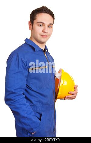 Construction worker in overalls with a yellow hard hat in his hand Stock Photo