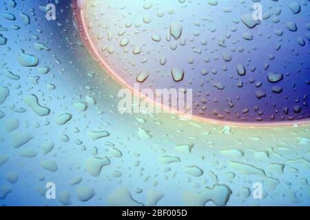 Water droplet on surface of bright silver blue pool float balloon Stock Photo