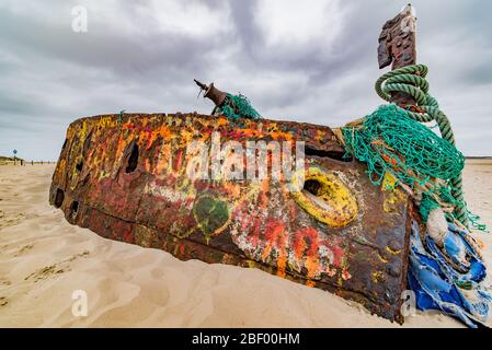 Rusty shipwreck with grafiti on island of Norderney, germany Stock Photo