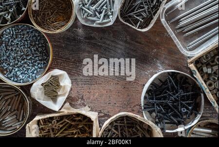 Various hardware, nails, screws and bolts in boxes. Home workshop. Top view Stock Photo