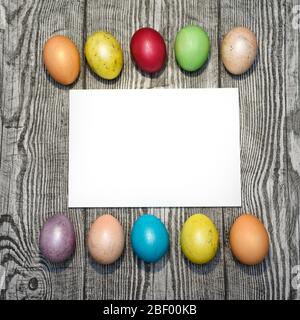 Many multi colored easter eggs on the wooden background. Space for text. Stock Photo