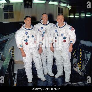 (1 Nov. 1968) --- The prime crew of the Apollo 8 lunar orbit mission stands beside the gondola in Building 29 after suiting up for centrifuge training in the Manned Spacecraft Center's (MSC) Flight Acceleration Facility (FAF). Left to right, are astronauts William A. Anders, lunar module pilot; James A. Lovell Jr., command module pilot; and Frank Borman, commander. Stock Photo