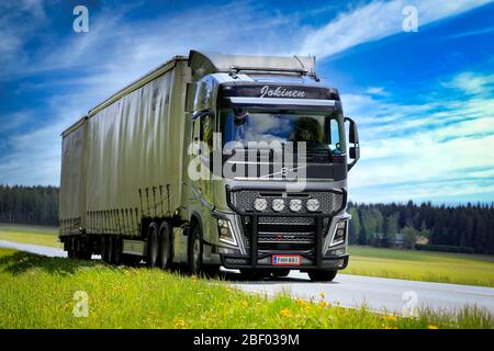 Silver Volvo FH truck Jokinen with RST-Steel bull bar pulls freight trailer on highway 2 on beautiful day of spring. Humppila, Finland. May 31, 2019. Stock Photo
