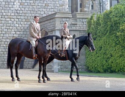6/8/1982 President Reagan and Queen Elizabeth II horseback riding at Windsor Castle in England Stock Photo