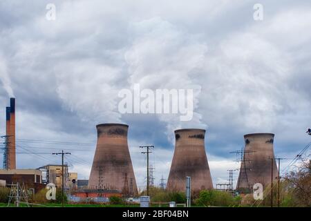 three huge chimneys smoking at the power plant and polluting the air Stock Photo