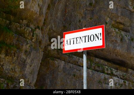 Warning sign Attention in the mountains. Tablet with inscription Stock Photo