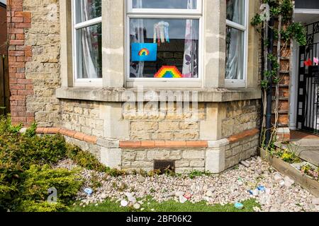 Chippenham, Wiltshire UK, 16th April, 2020. With the nation due to once again clap to show their support for the NHS tonight, a childs rainbow artwork (a symbol of support for people wanting to show solidarity with NHS workers) is pictured in a front window of a home in Chippenham, Wiltshire. Credit: Lynchpics/Alamy Live News Stock Photo