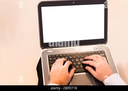 Hands of a man using a laptop with an empty screen. Stock Photo