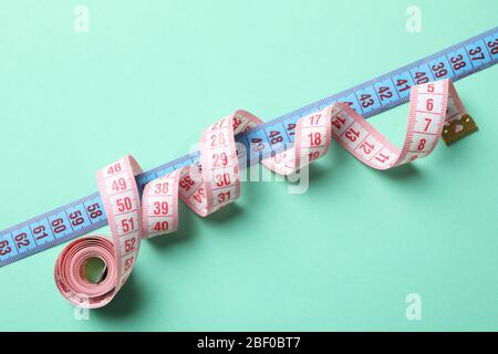 Measuring tape on mint background. Weight loss concept Stock Photo