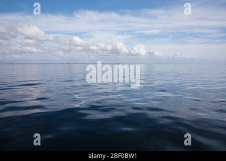 The Indian Ocean is glassy and peaceful on a scenic calm boat ride through Algoa Bay, Nelson Mandela Bay, Port Elizabeth, Eastern Cape, South Africa. Stock Photo