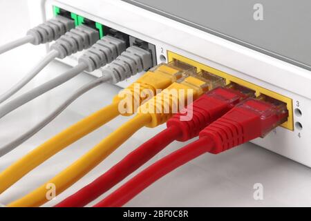 Wireless Modem router with ethernet network hub with cables connecting Stock Photo