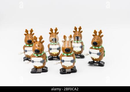 Group of six novelty plastic wind-up models of Santa's reindeer holding signs with their names Stock Photo