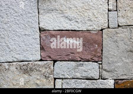 Wall made of rock pieces cut in rectangular shape. Stock Photo
