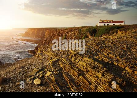 House in the cliff on the Atlantic Ocean coast in the Alentejo region in Portugal Stock Photo